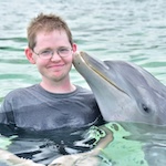 Michael with a dolphin in Roatan, Honduras